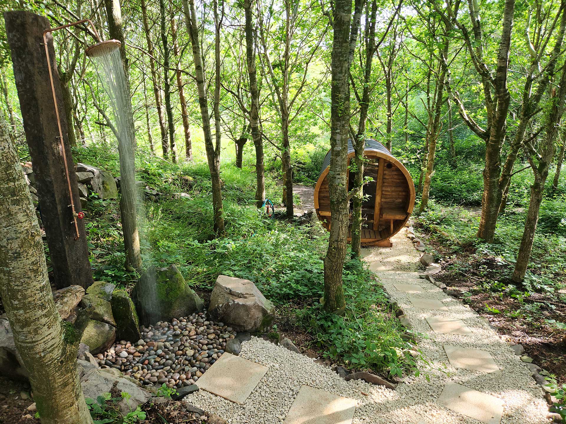 Ballyburren's wood-fired barrel sauna nestled among woodland trees